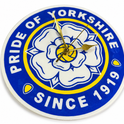 A round wall clock featuring the Yorkshire club crest with a white rose, blue and yellow rings, and gold hands. The text reads 'PRIDE OF YORKSHIRE' and 'SINCE 1919'.